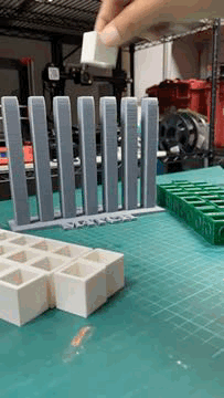 timelapse of a match four game being played with white and green cubes. white cubes player forms a diagonal of 4 to win. loop continues from start of game